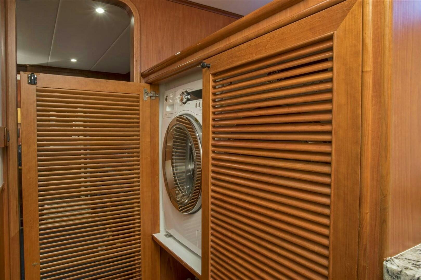 a wooden closet with a fan aboard INSIGNIA Yacht for Sale