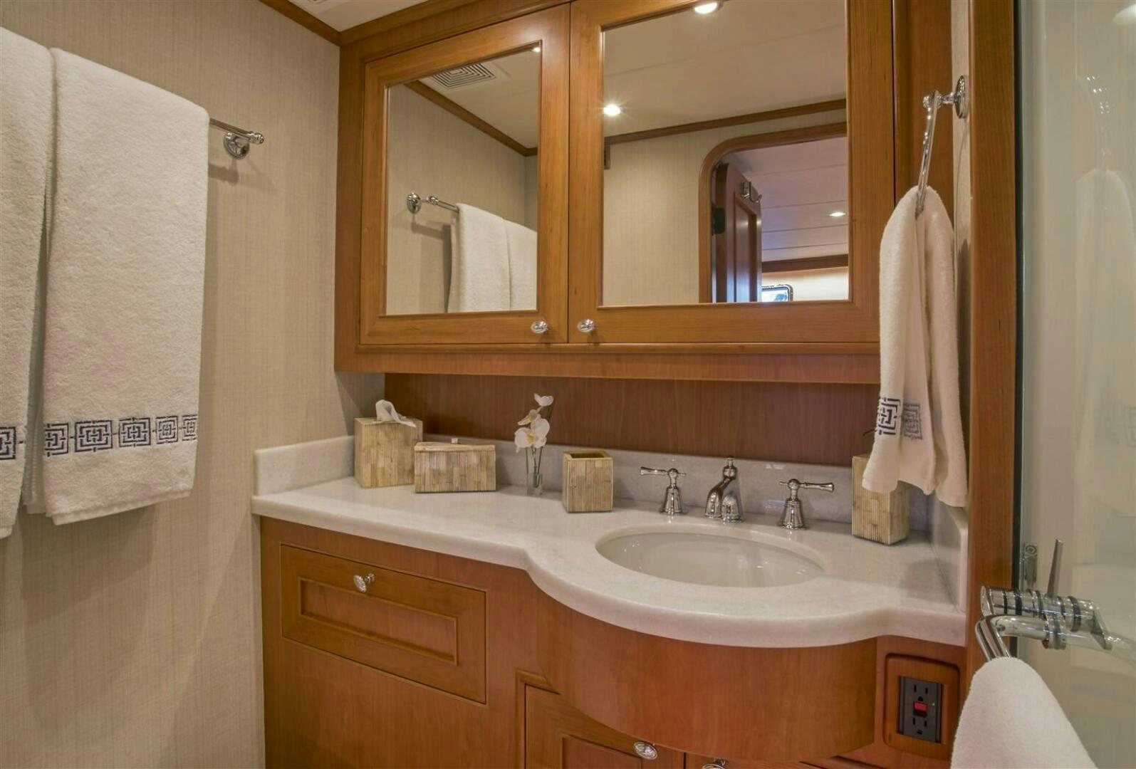 a bathroom with a sink and towels aboard INSIGNIA Yacht for Sale