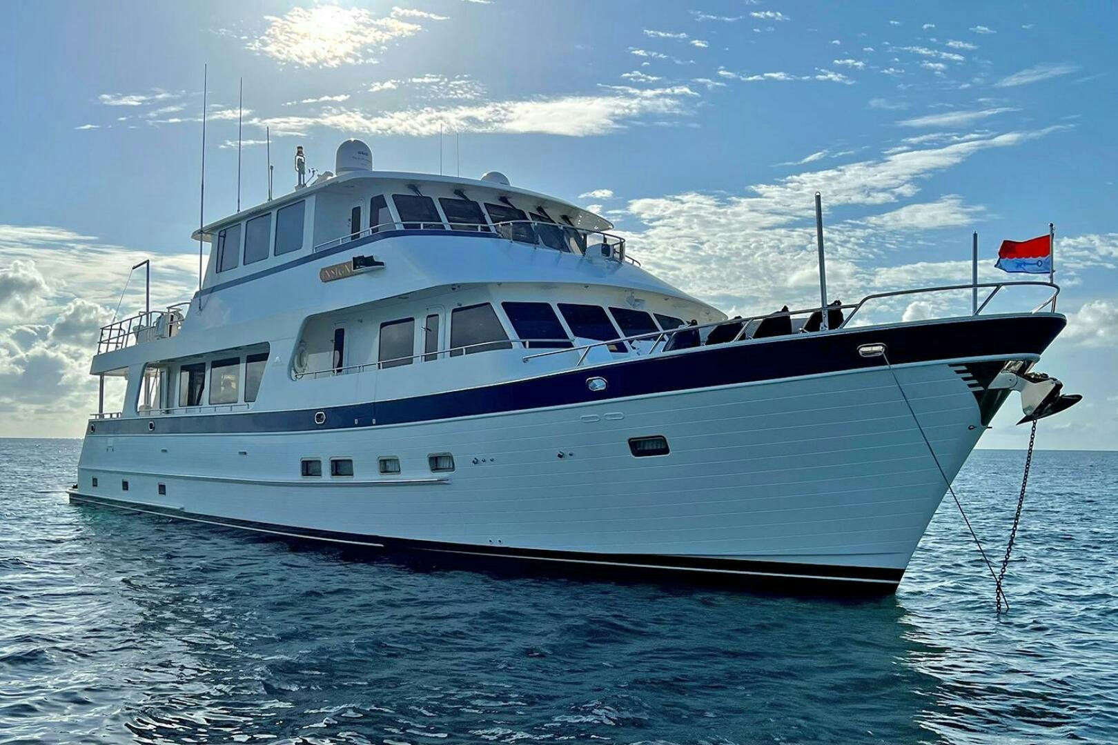 a large white boat in the water aboard INSIGNIA Yacht for Sale