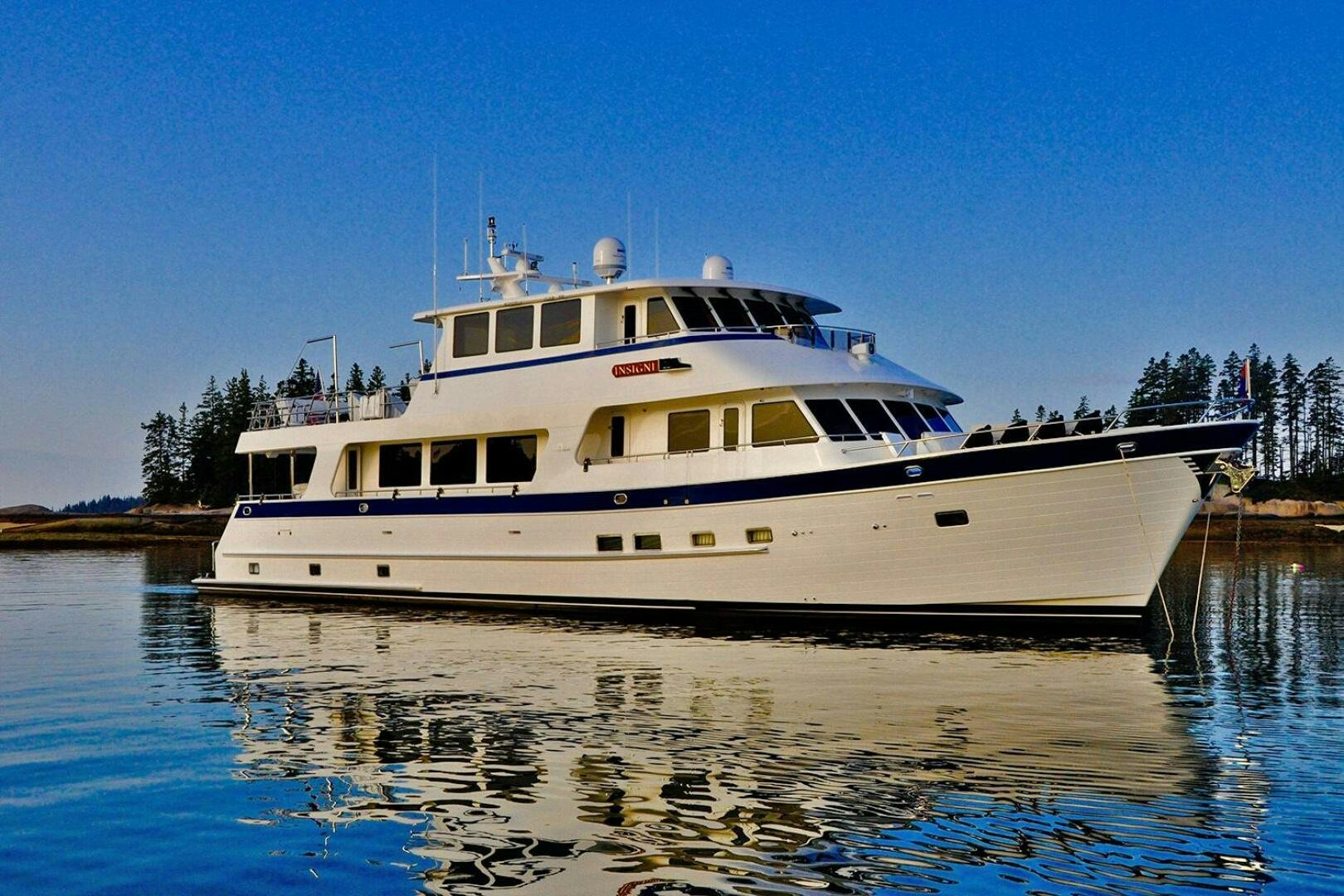 a large white boat on the water aboard INSIGNIA Yacht for Sale