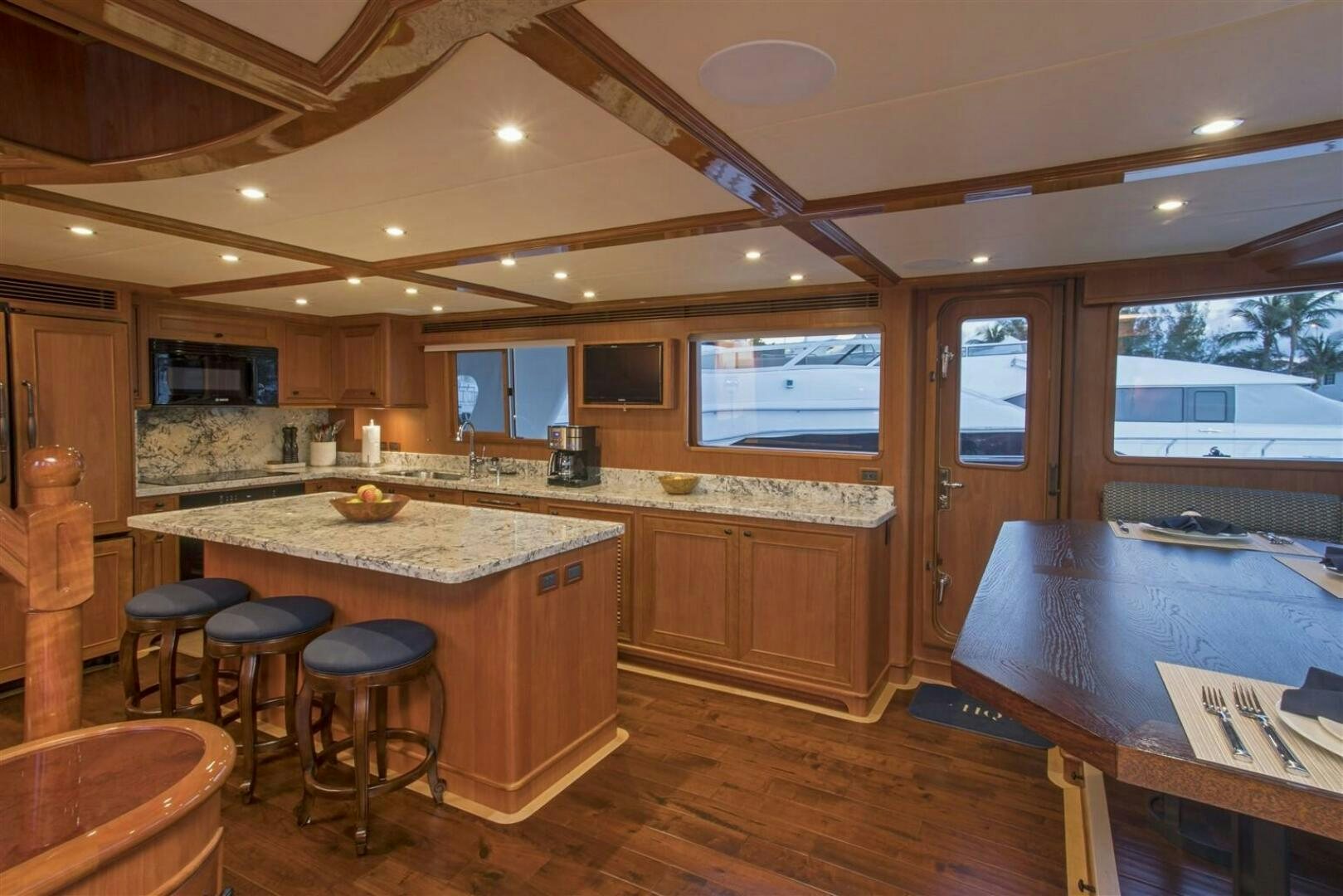 a kitchen with a bar and stools aboard INSIGNIA Yacht for Sale