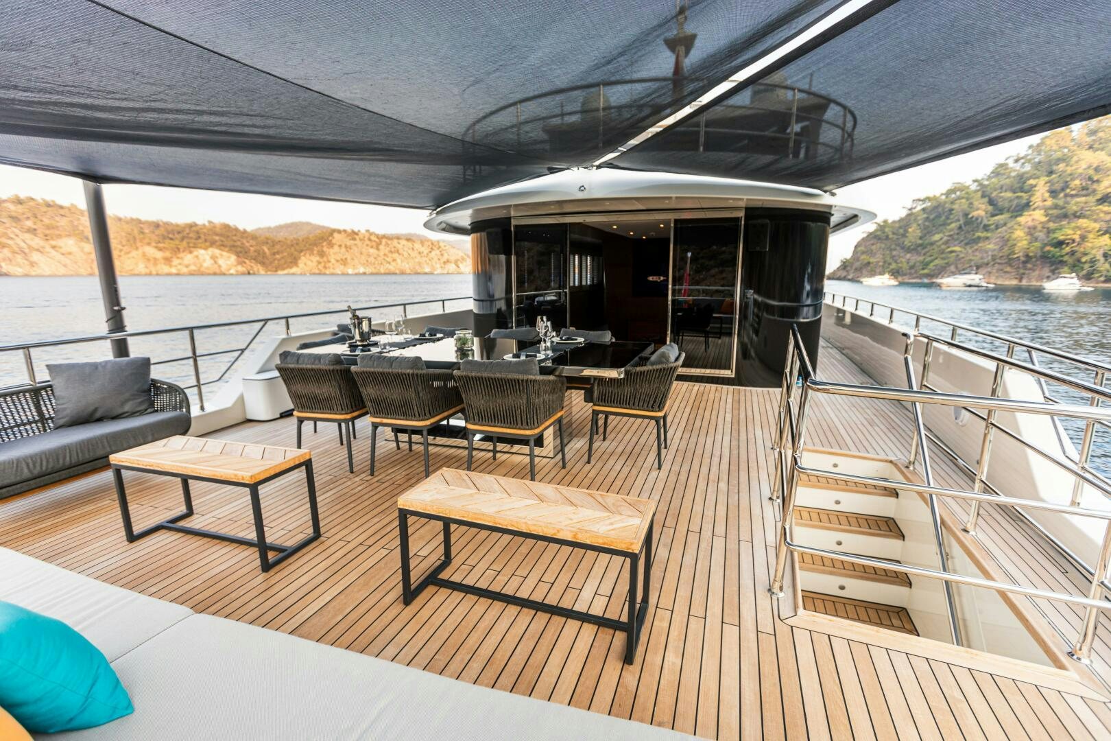 a deck with a table and chairs on it aboard ZEEMAR Yacht for Sale