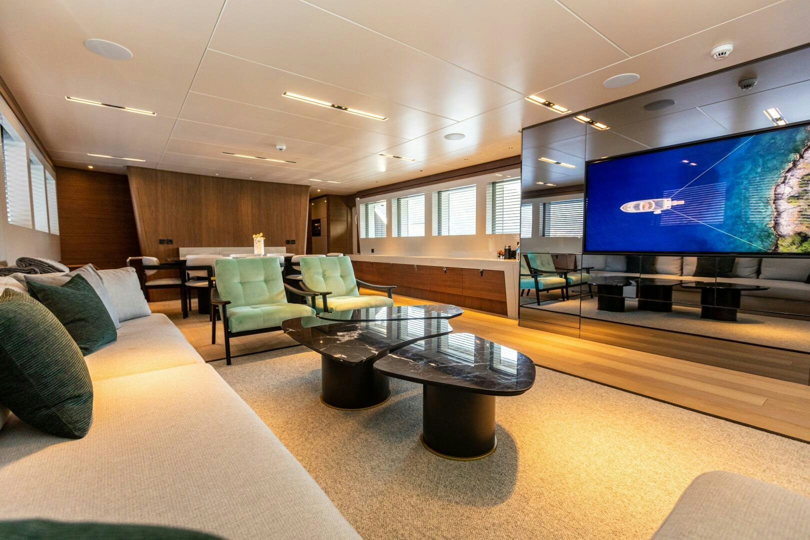 a living room with a large screen aboard ZEEMAR Yacht for Sale
