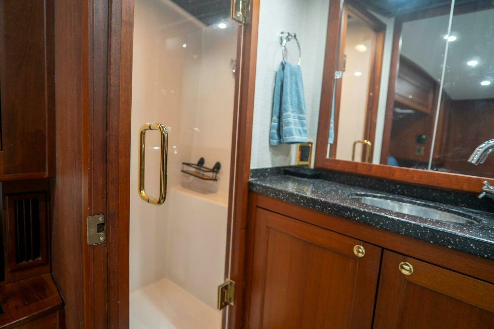 a bathroom with a sink and a mirror aboard BIG BLUE Yacht for Sale