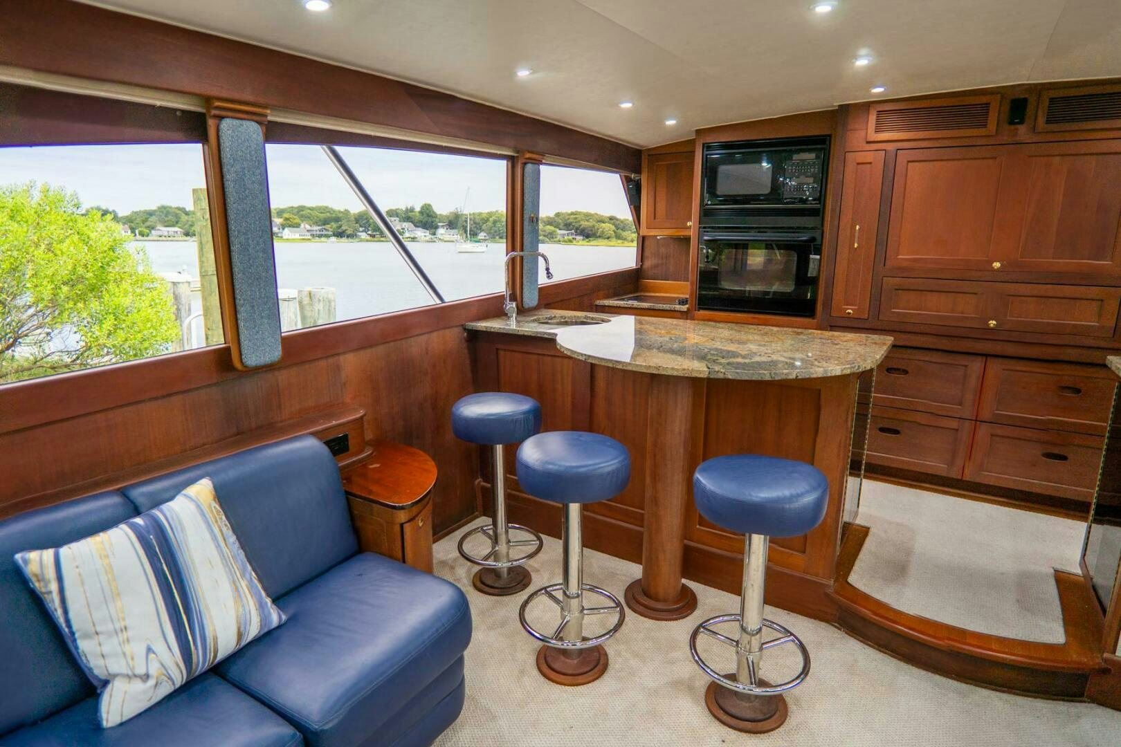 a living room with a couch and a table aboard BIG BLUE Yacht for Sale