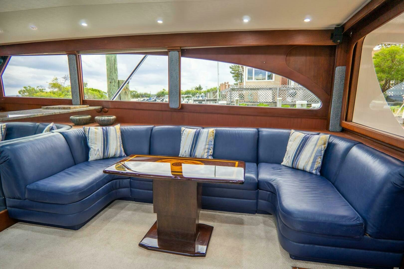 a couch with a coffee table aboard BIG BLUE Yacht for Sale