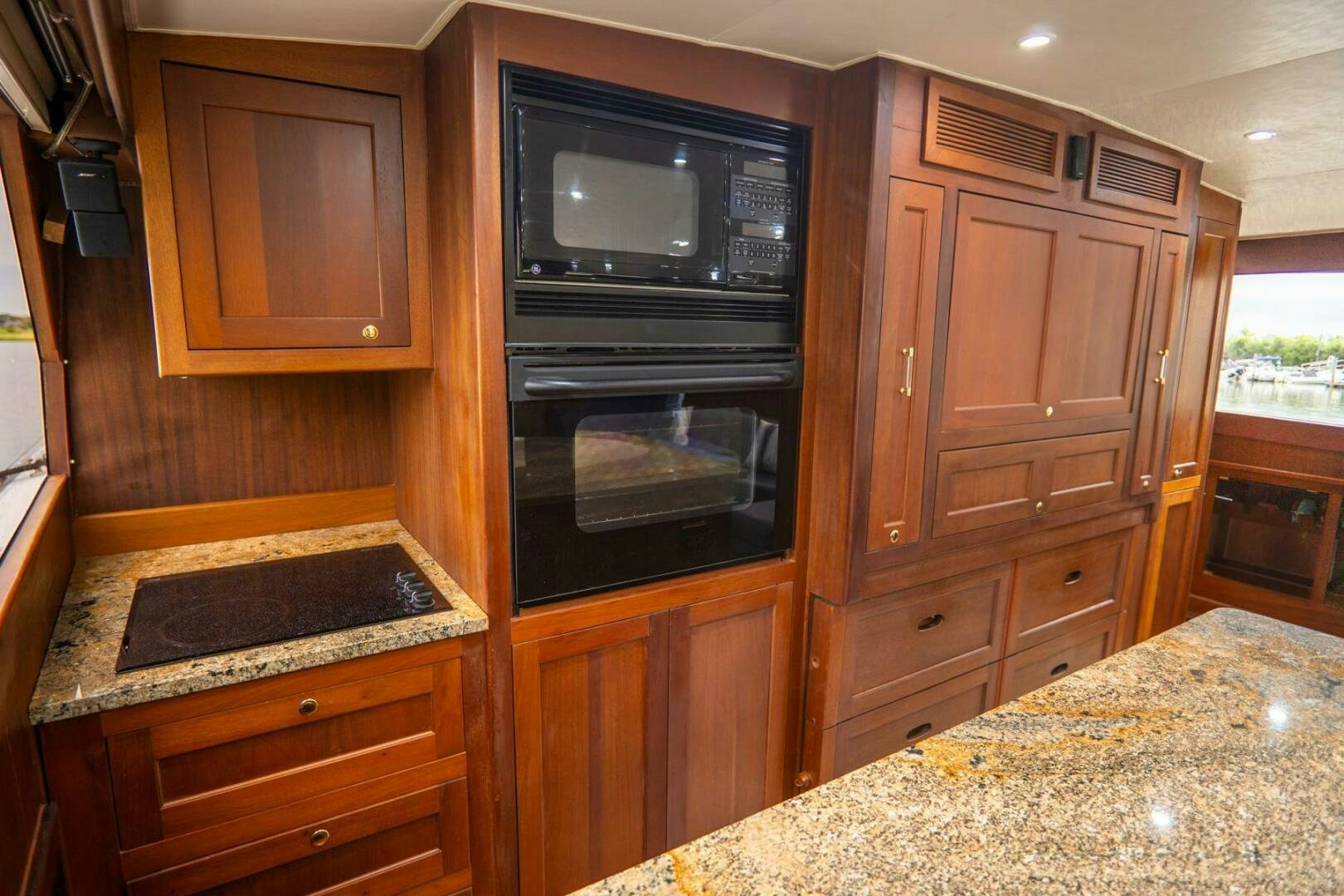 a kitchen with wooden cabinets aboard BIG BLUE Yacht for Sale