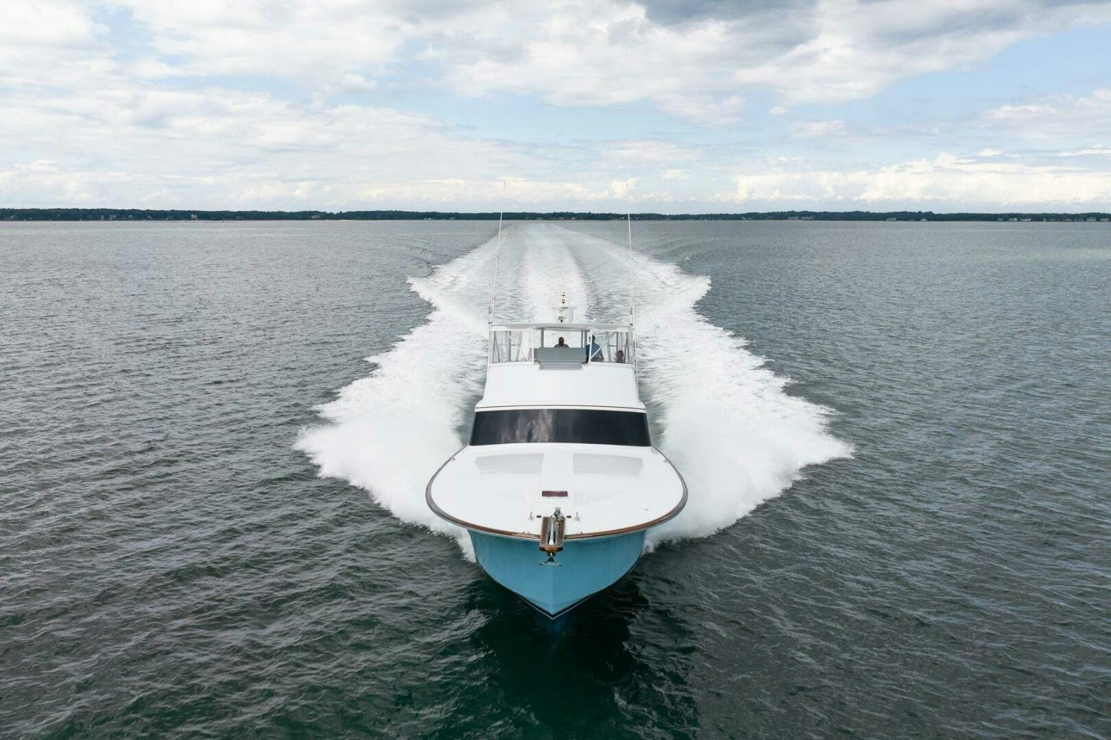 a small white boat in the water aboard BIG BLUE Yacht for Sale