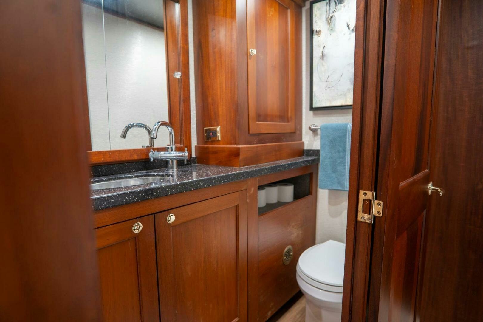 a bathroom with a sink and toilet aboard BIG BLUE Yacht for Sale