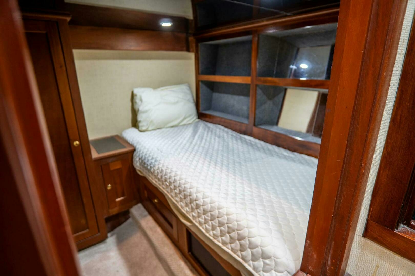 a bed with white sheets aboard BIG BLUE Yacht for Sale