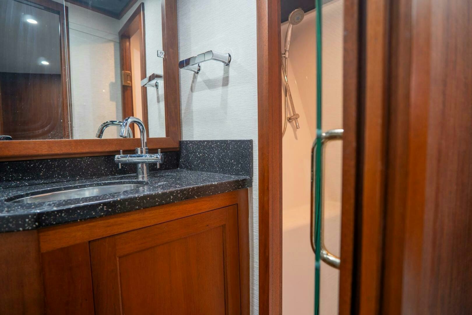 a bathroom with a sink and a mirror aboard BIG BLUE Yacht for Sale