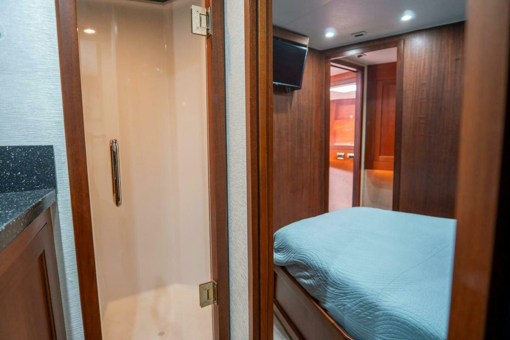 a bedroom with a bed and a closet aboard BIG BLUE Yacht for Sale