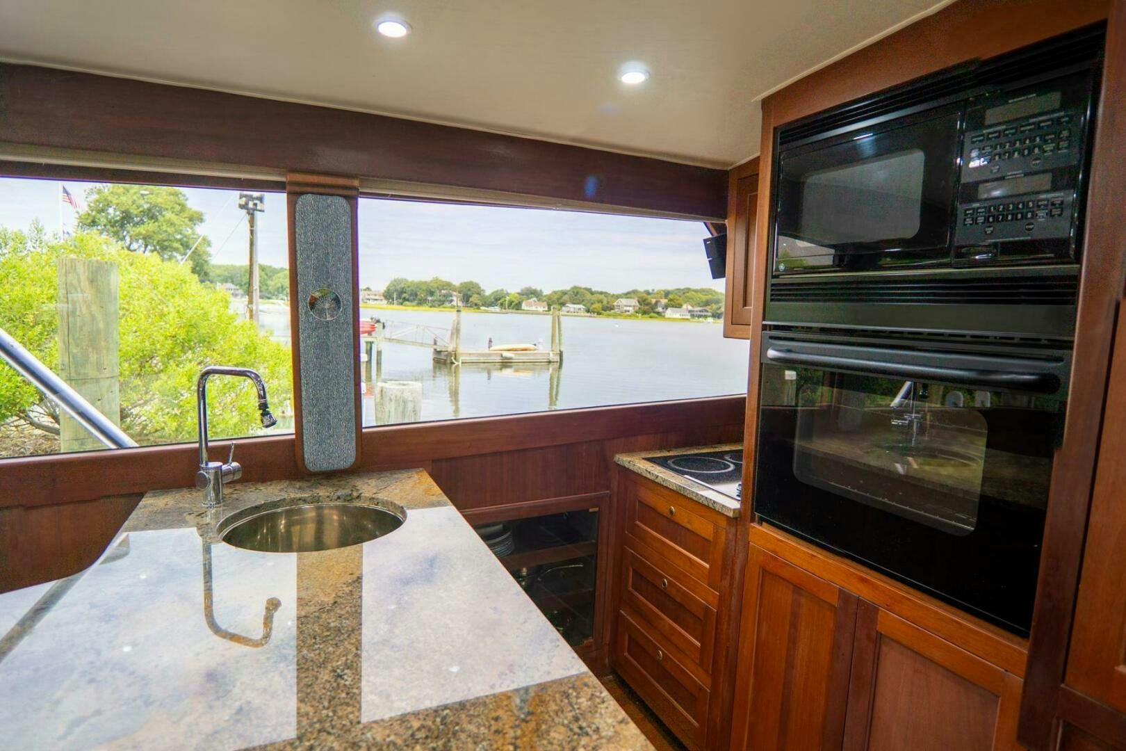 a kitchen with a marble counter top aboard BIG BLUE Yacht for Sale