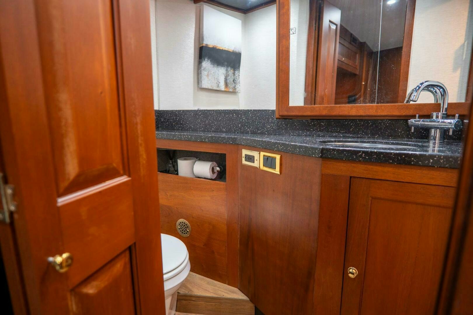 a bathroom with a sink and a toilet aboard BIG BLUE Yacht for Sale