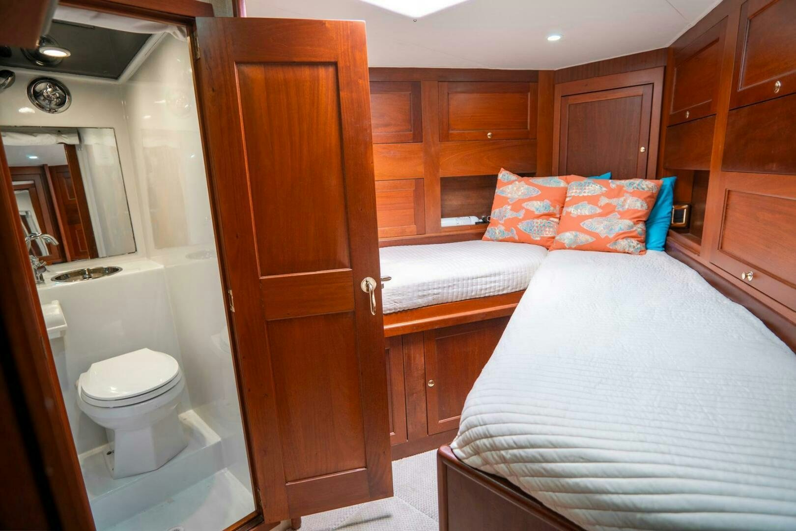 a bedroom with a bed and a closet aboard BIG BLUE Yacht for Sale