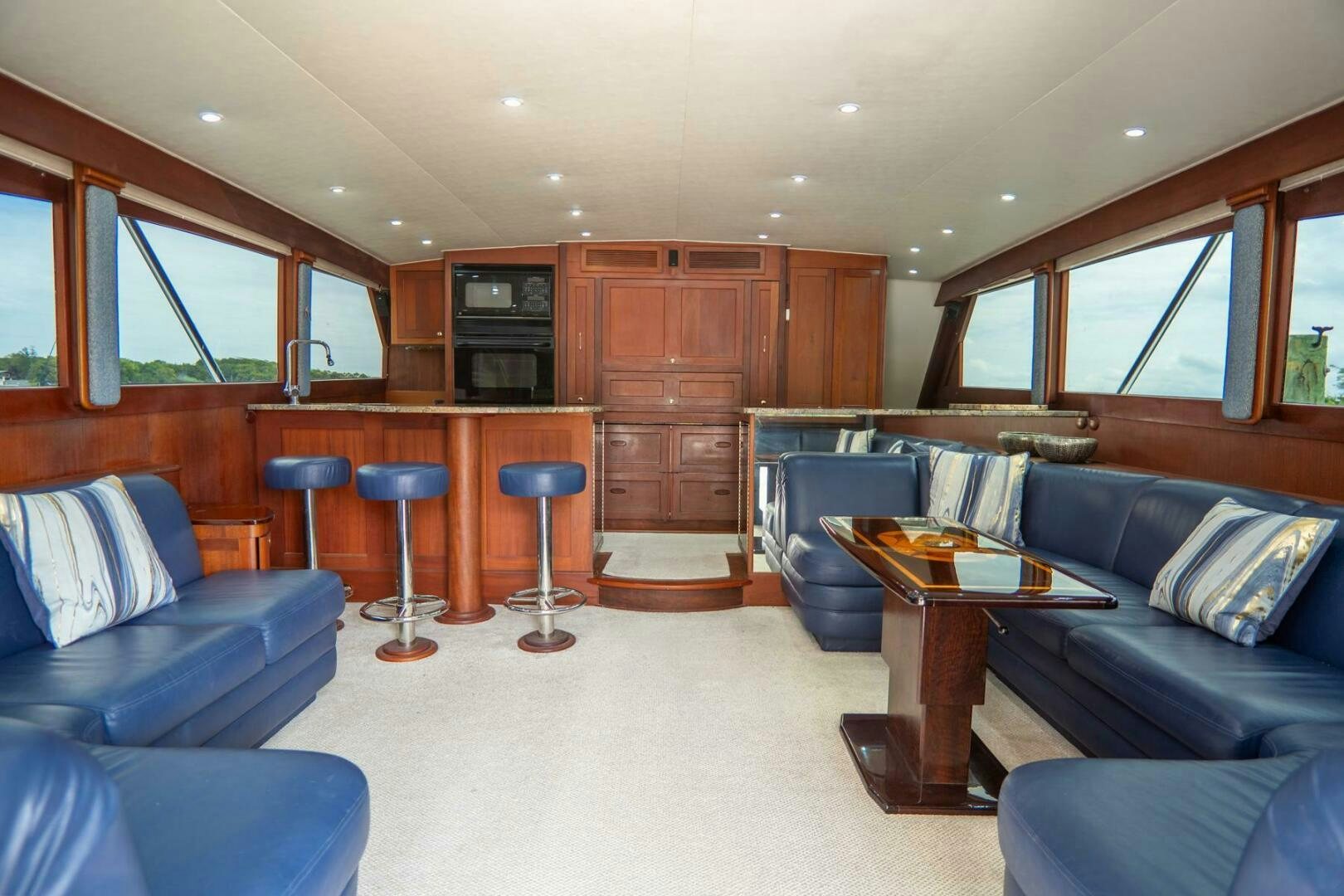 a living room with a couch and a coffee table aboard BIG BLUE Yacht for Sale