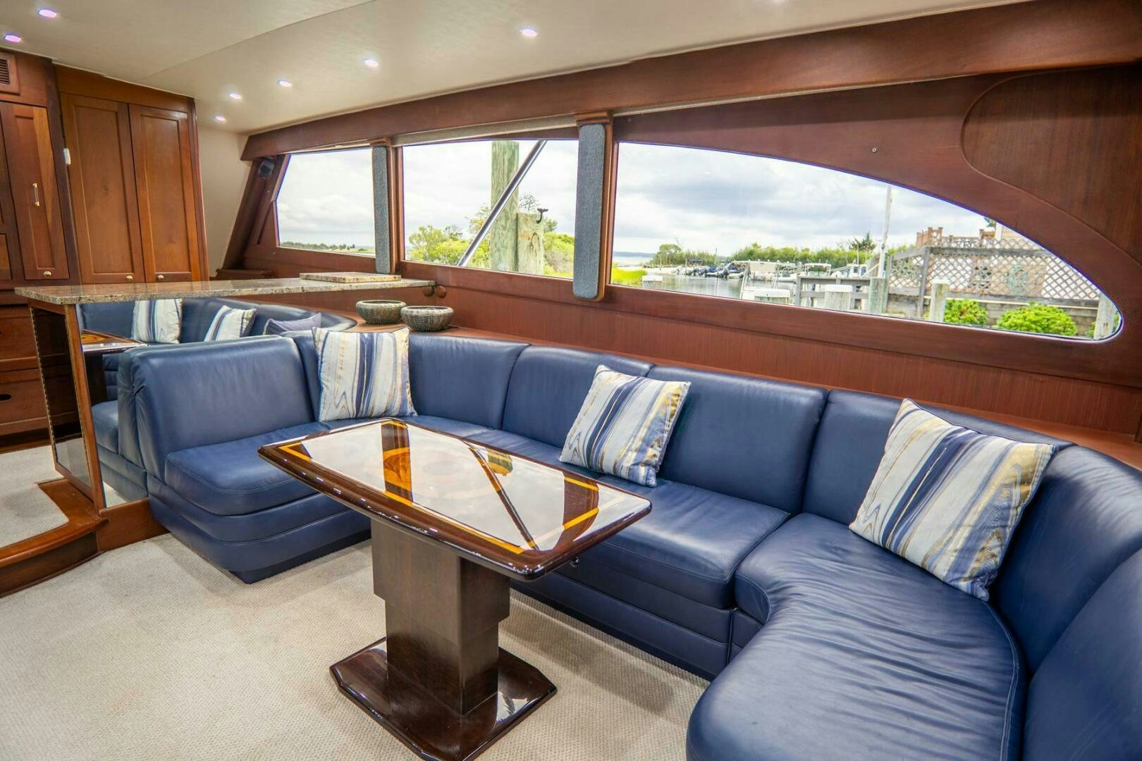 a living room with a blue couch aboard BIG BLUE Yacht for Sale