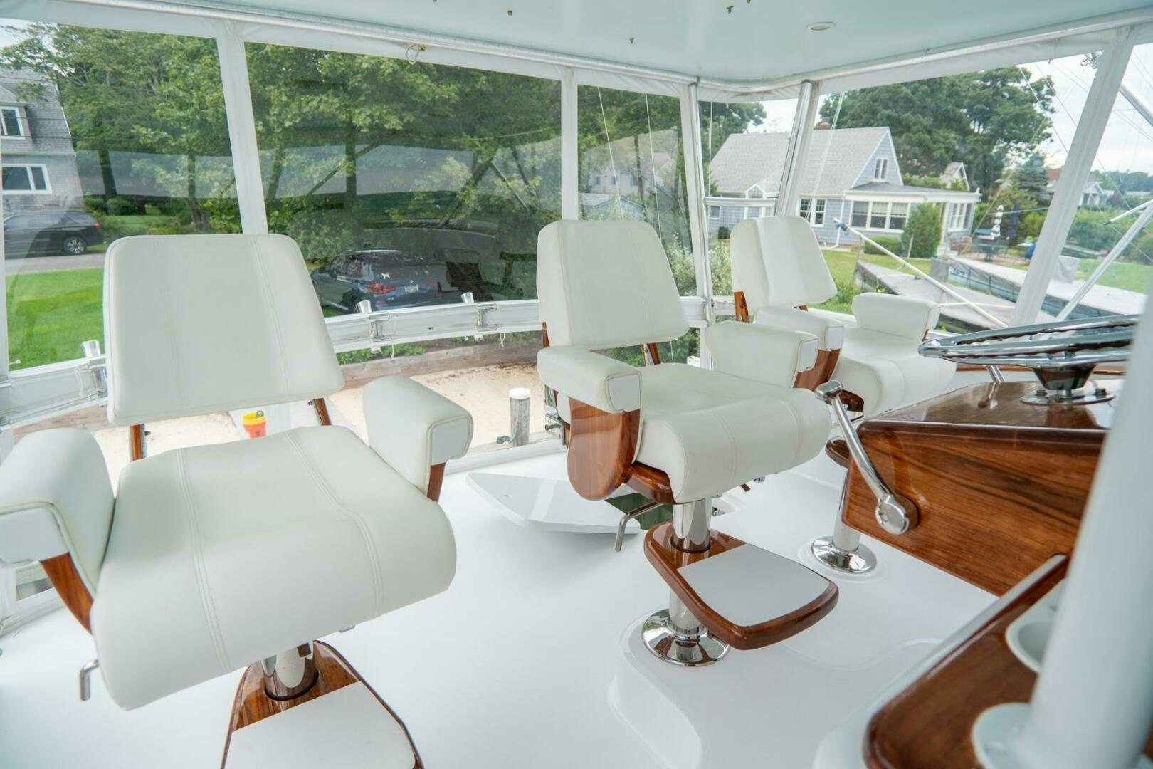 a room with chairs and a table aboard BIG BLUE Yacht for Sale