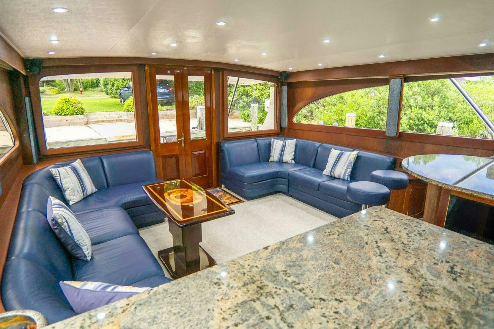 a living room with a couch and a coffee table aboard BIG BLUE Yacht for Sale