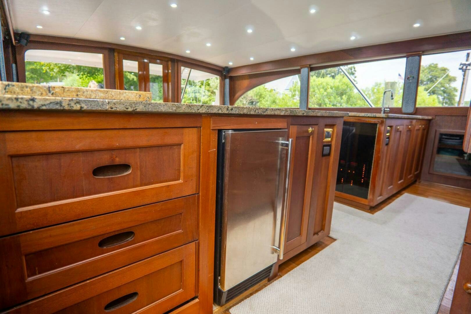 a room with wooden cabinets aboard BIG BLUE Yacht for Sale