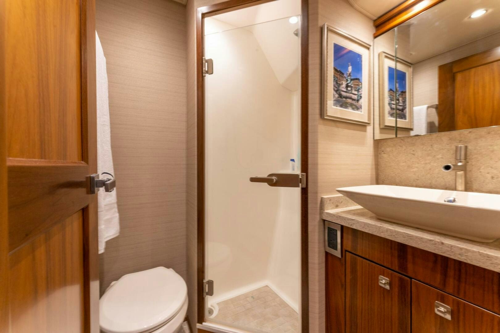 a bathroom with a toilet and sink aboard HIGH COTTON Yacht for Sale