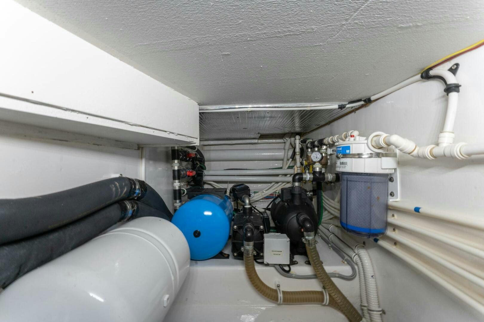 a white room with pipes and machinery aboard HIGH COTTON Yacht for Sale