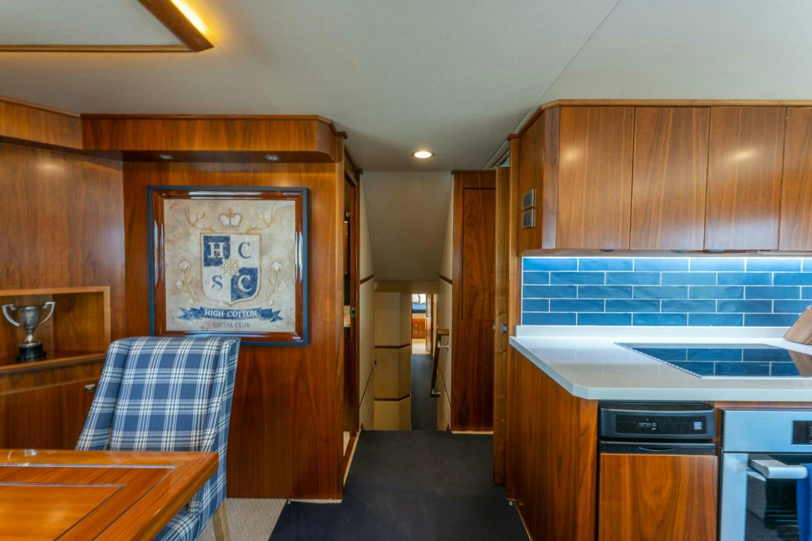 a kitchen with wooden cabinets aboard HIGH COTTON Yacht for Sale