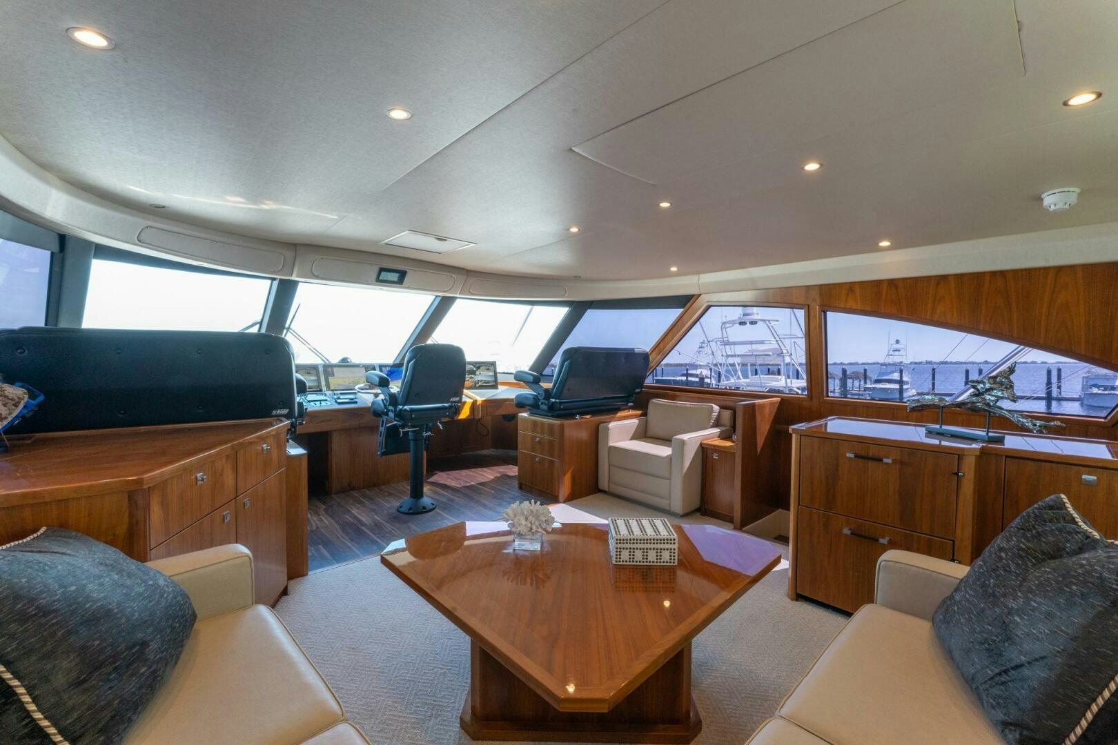 a living room with a tv and a table aboard HIGH COTTON Yacht for Sale