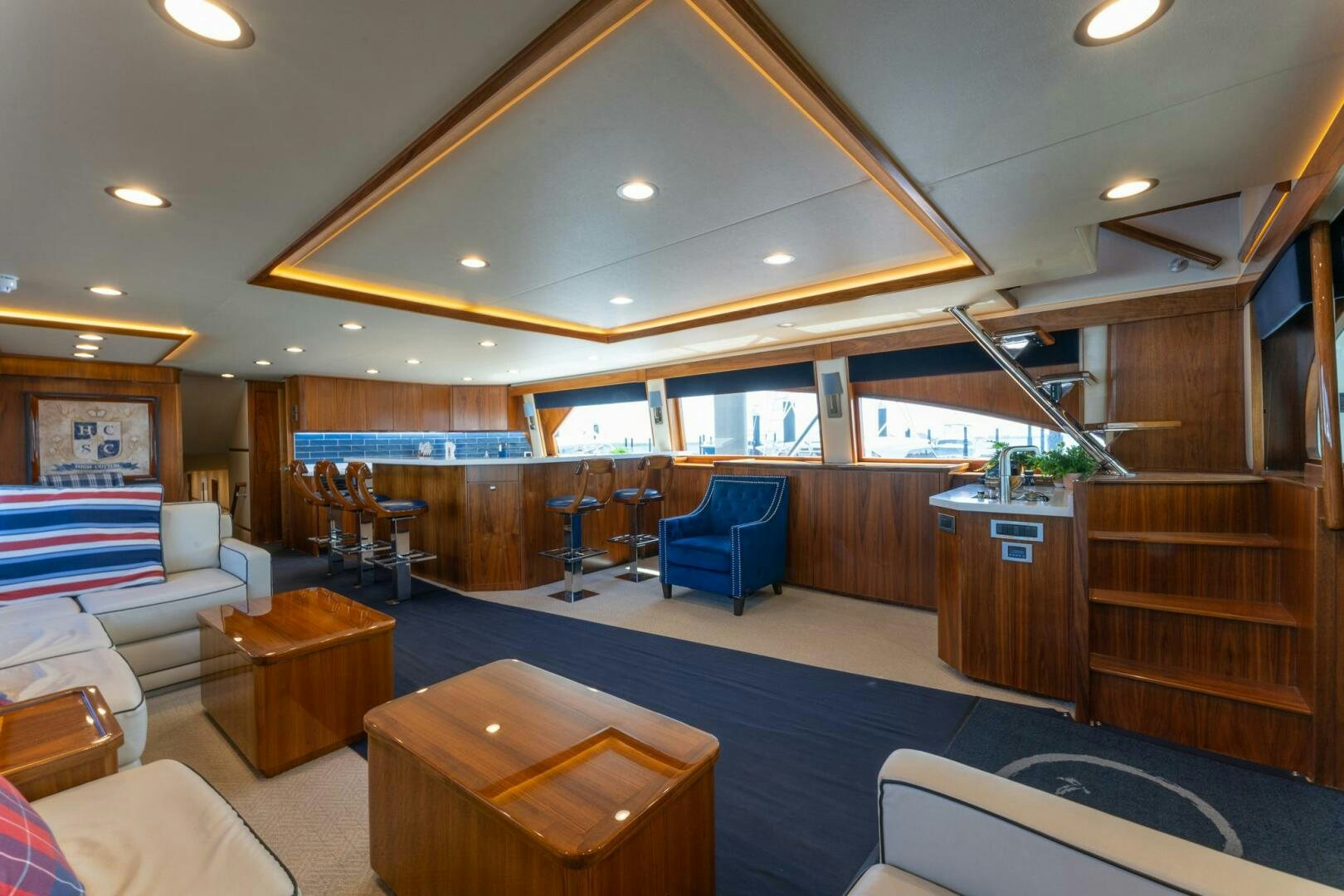 a room with a wood staircase and a wood table and chairs aboard HIGH COTTON Yacht for Sale