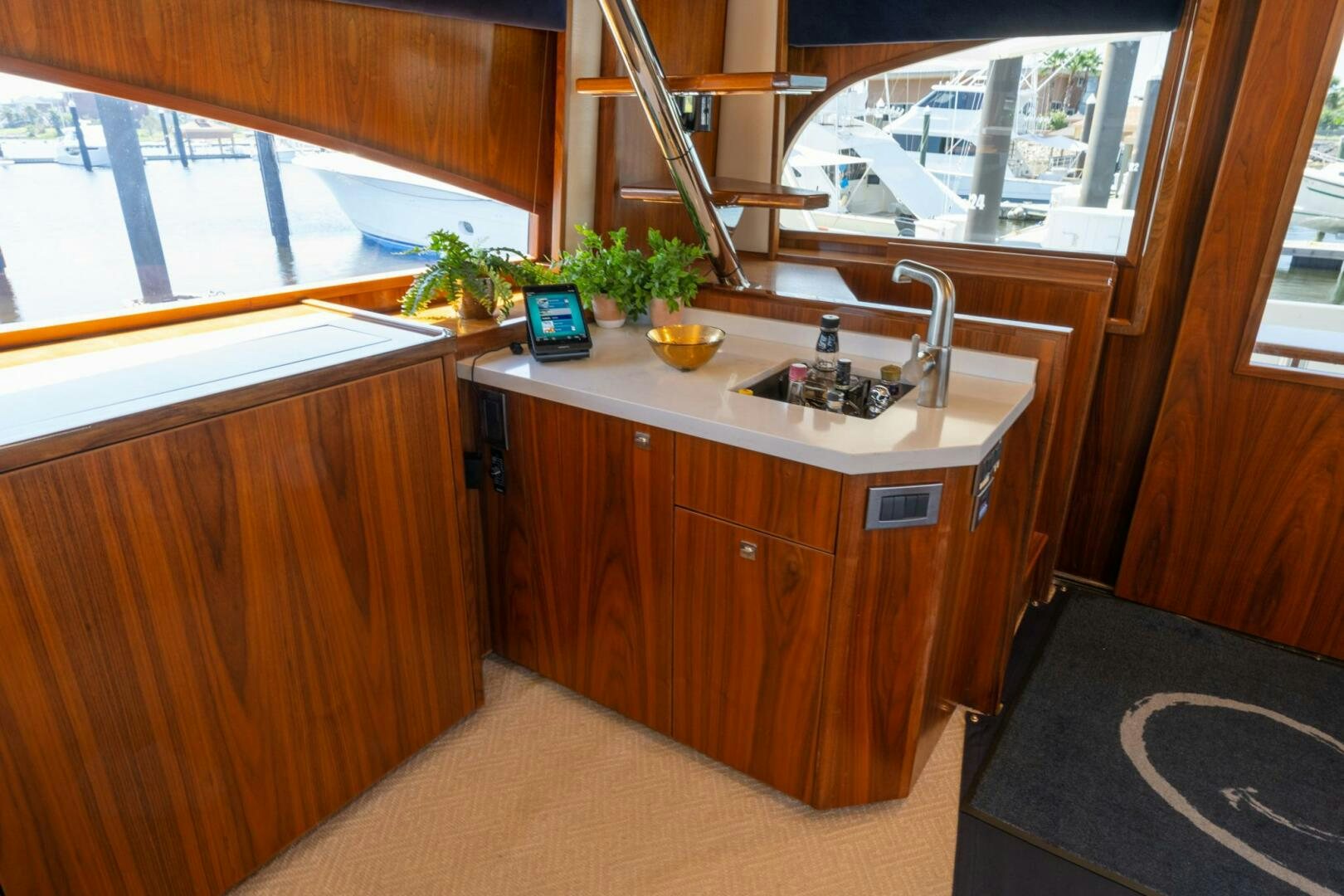 a small kitchen with a sink and a large window aboard HIGH COTTON Yacht for Sale