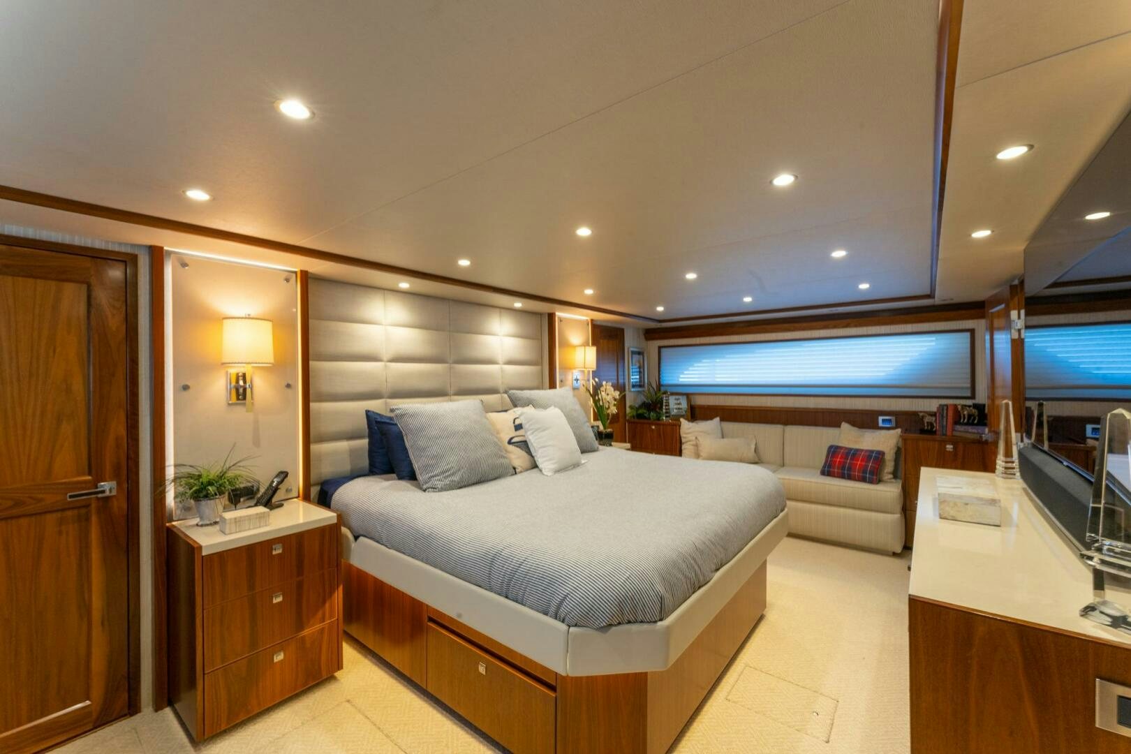 a bedroom with a bed and a tv aboard HIGH COTTON Yacht for Sale