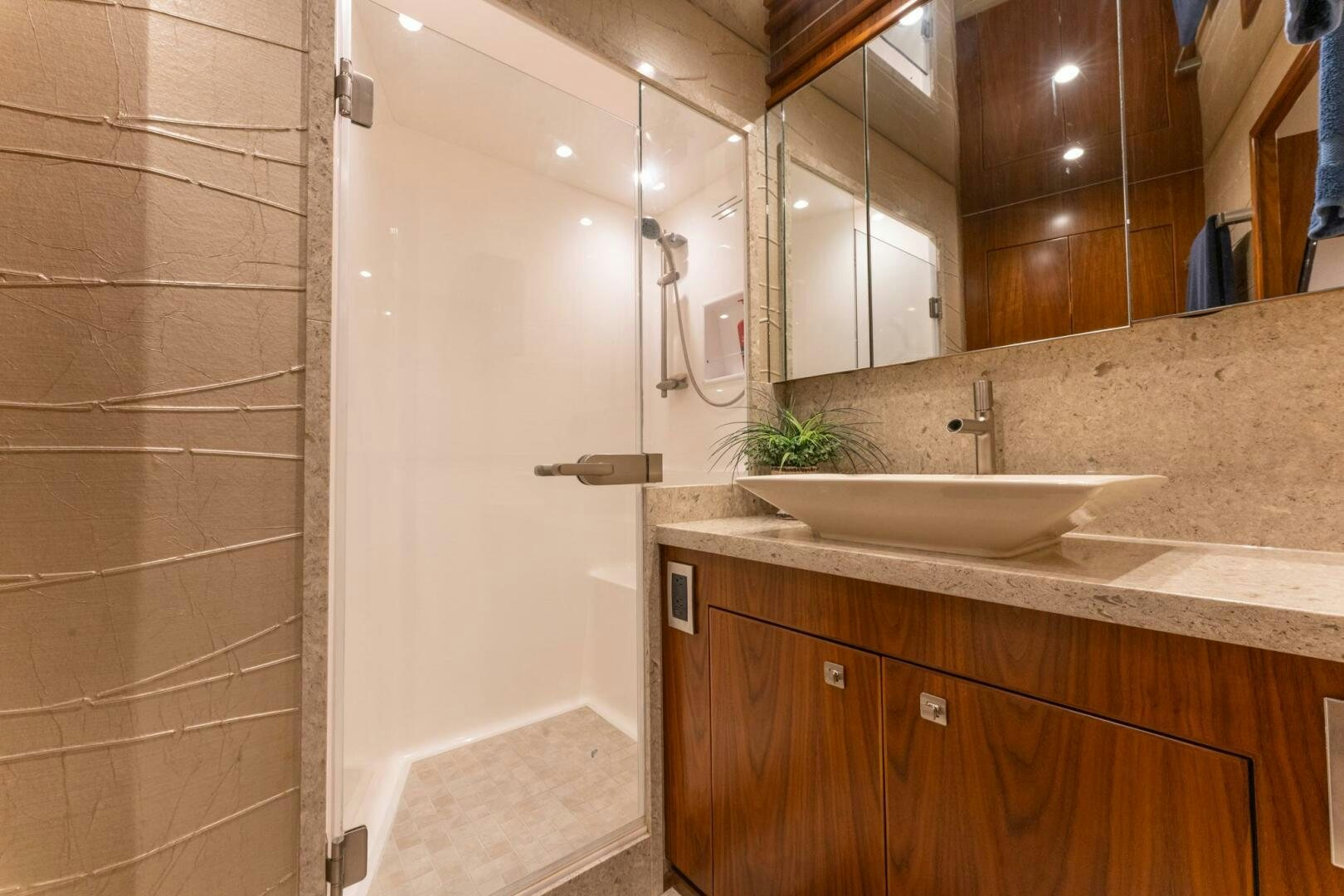 a bathroom with a sink and a mirror aboard HIGH COTTON Yacht for Sale