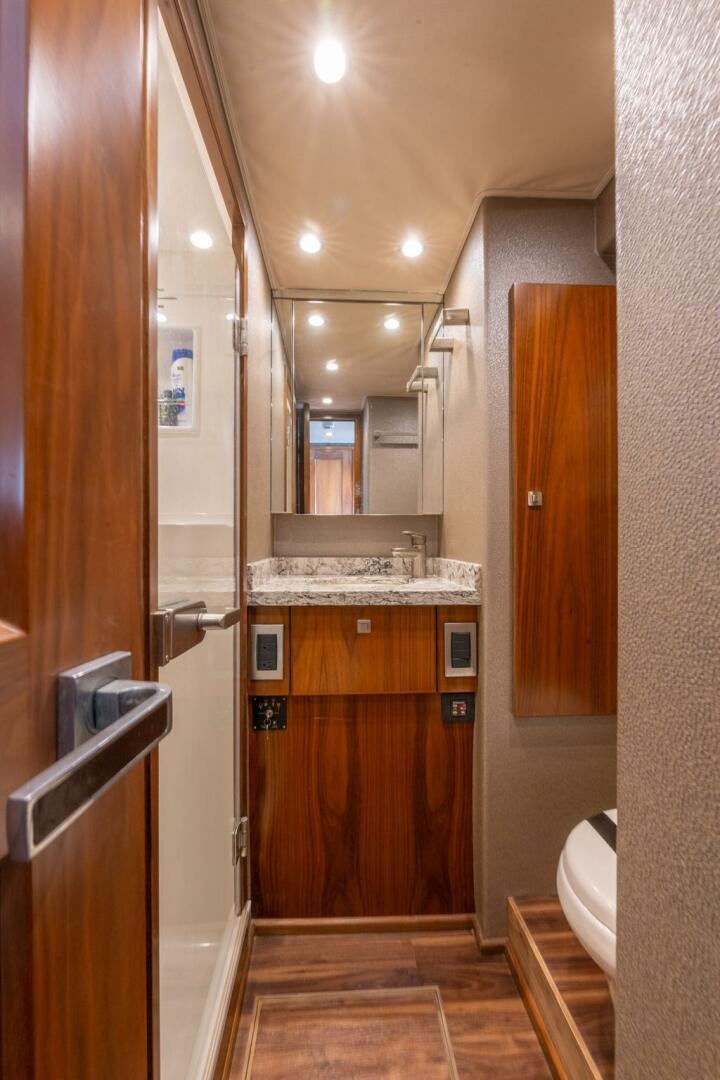 a bathroom with a sink and a mirror aboard HIGH COTTON Yacht for Sale