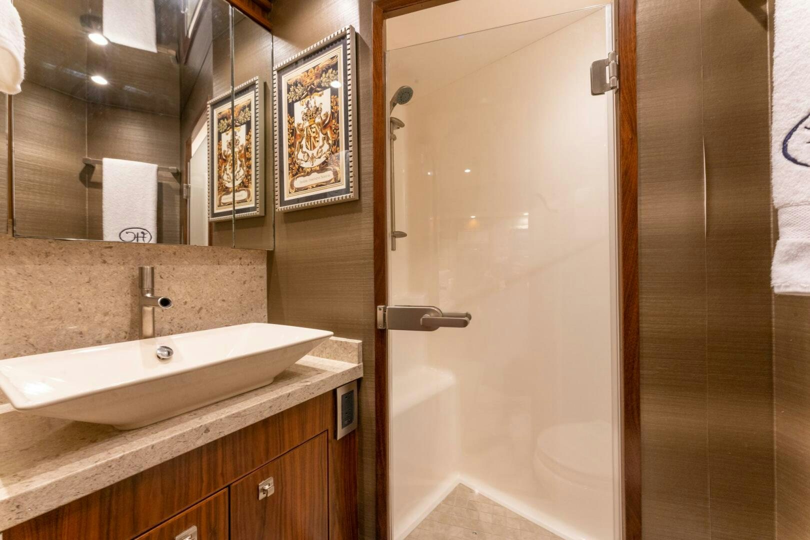 a bathroom with a sink and a mirror aboard HIGH COTTON Yacht for Sale