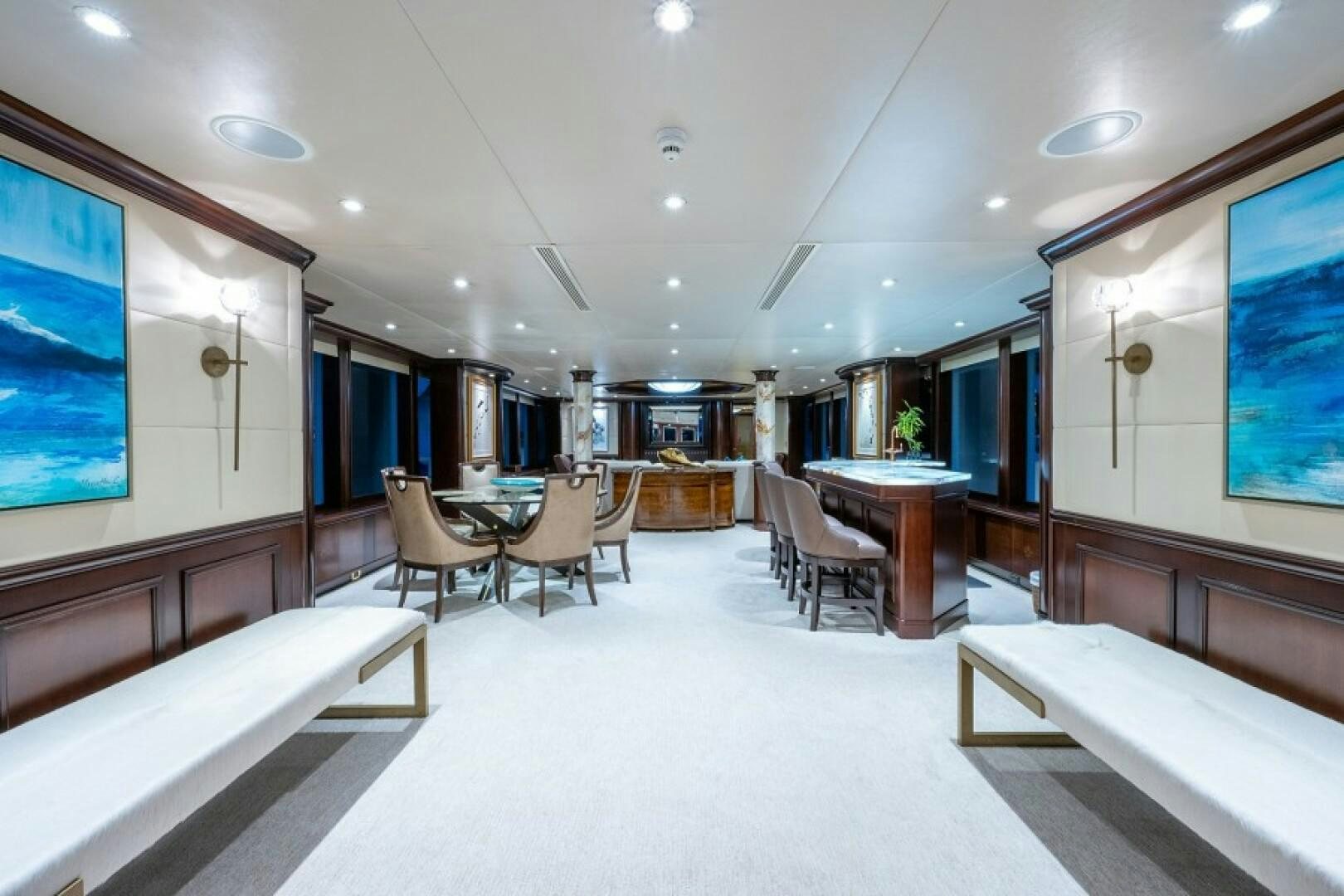 a room with a table chairs and a large window aboard STARSHIP Yacht for Sale
