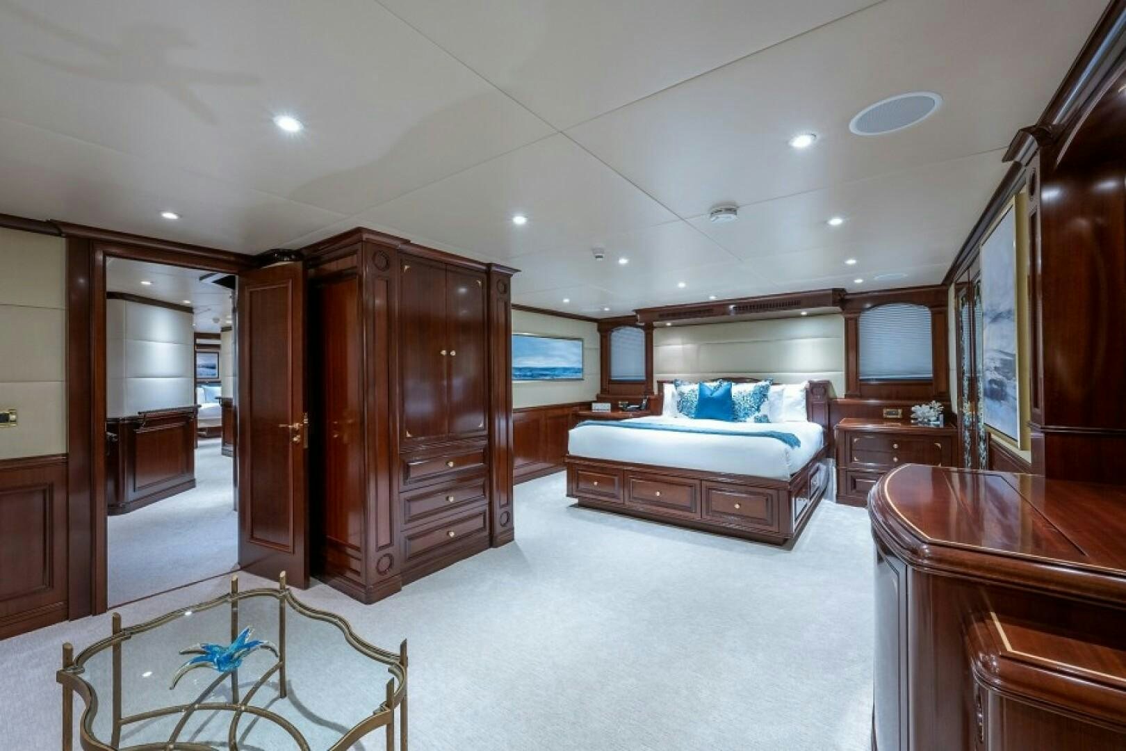 a bedroom with a bed and a closet aboard STARSHIP Yacht for Sale