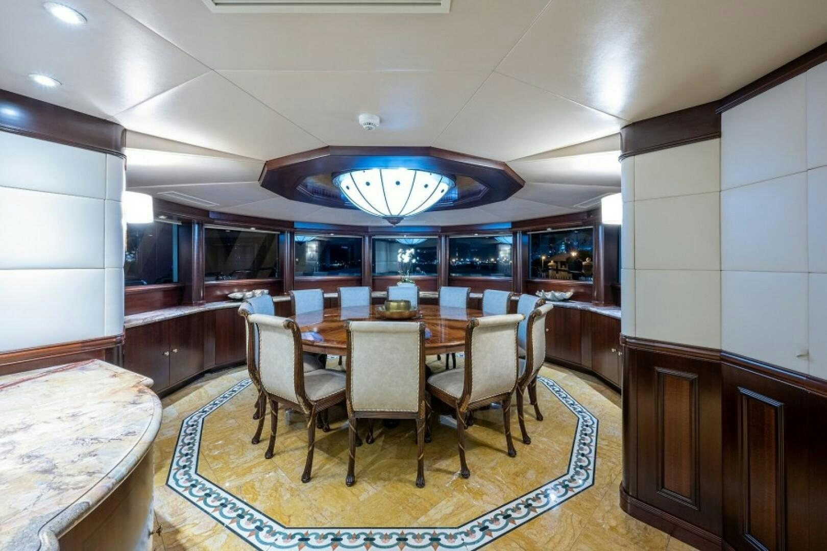 a dining room with a table and chairs aboard STARSHIP Yacht for Sale