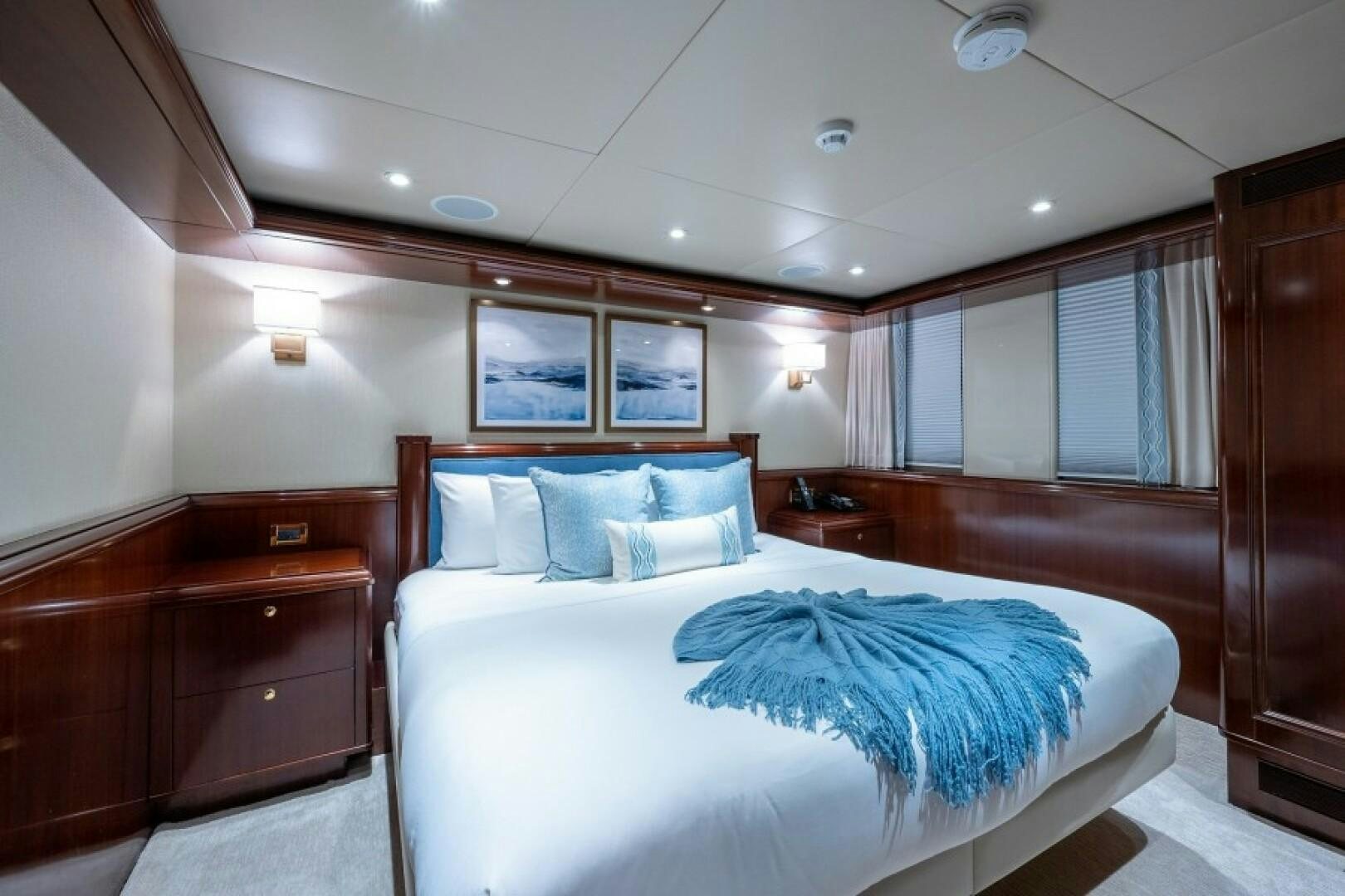 a bedroom with two beds aboard STARSHIP Yacht for Sale
