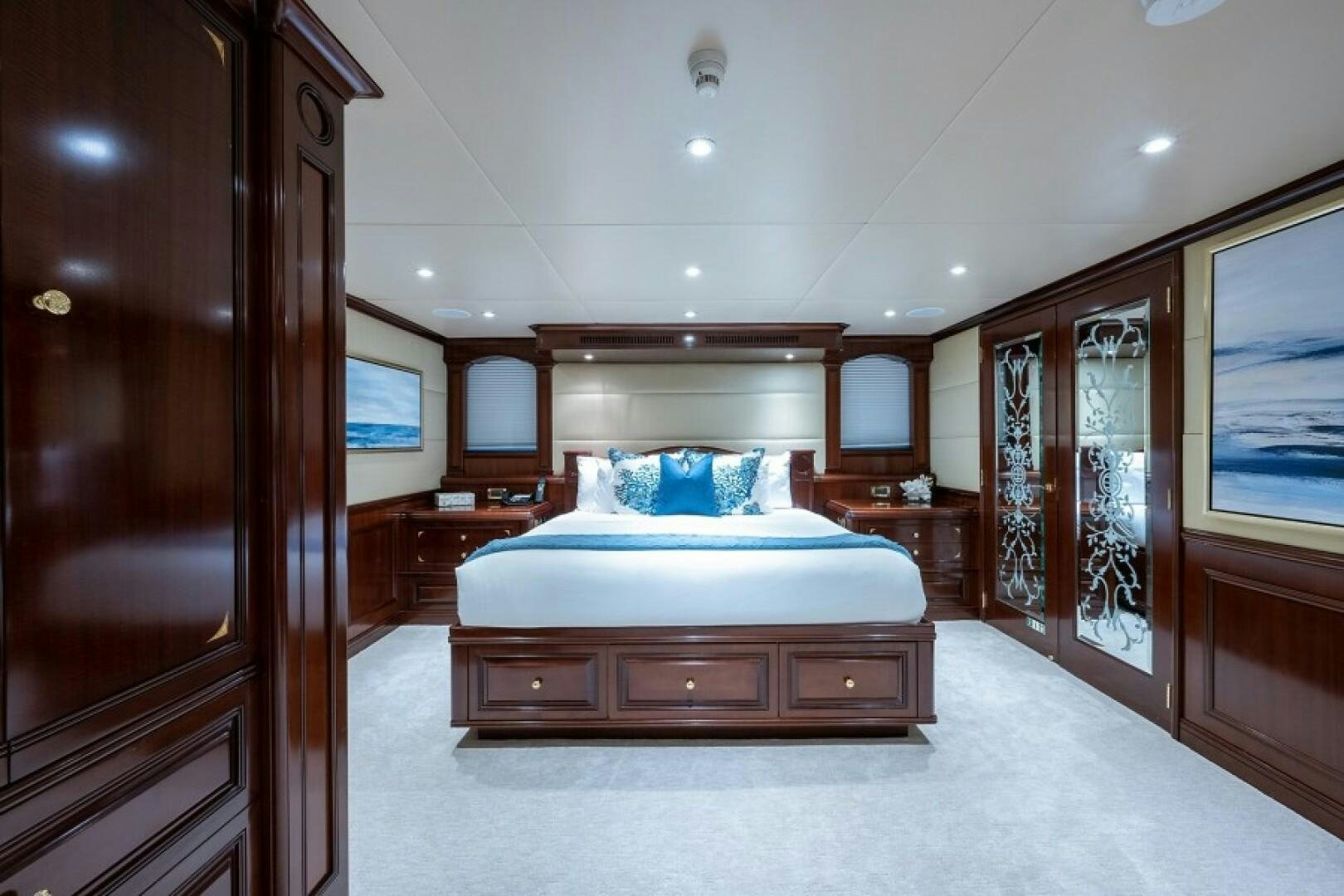 a bedroom with a bed and a closet aboard STARSHIP Yacht for Sale