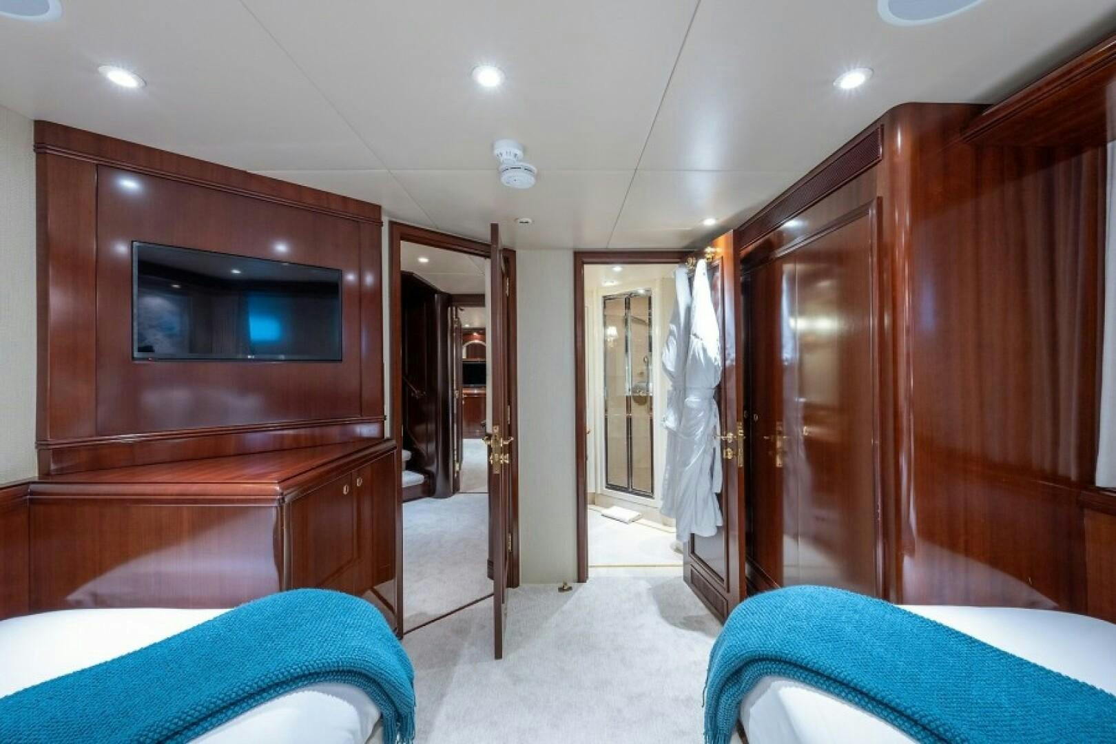 a room with a tv and a bed aboard STARSHIP Yacht for Sale