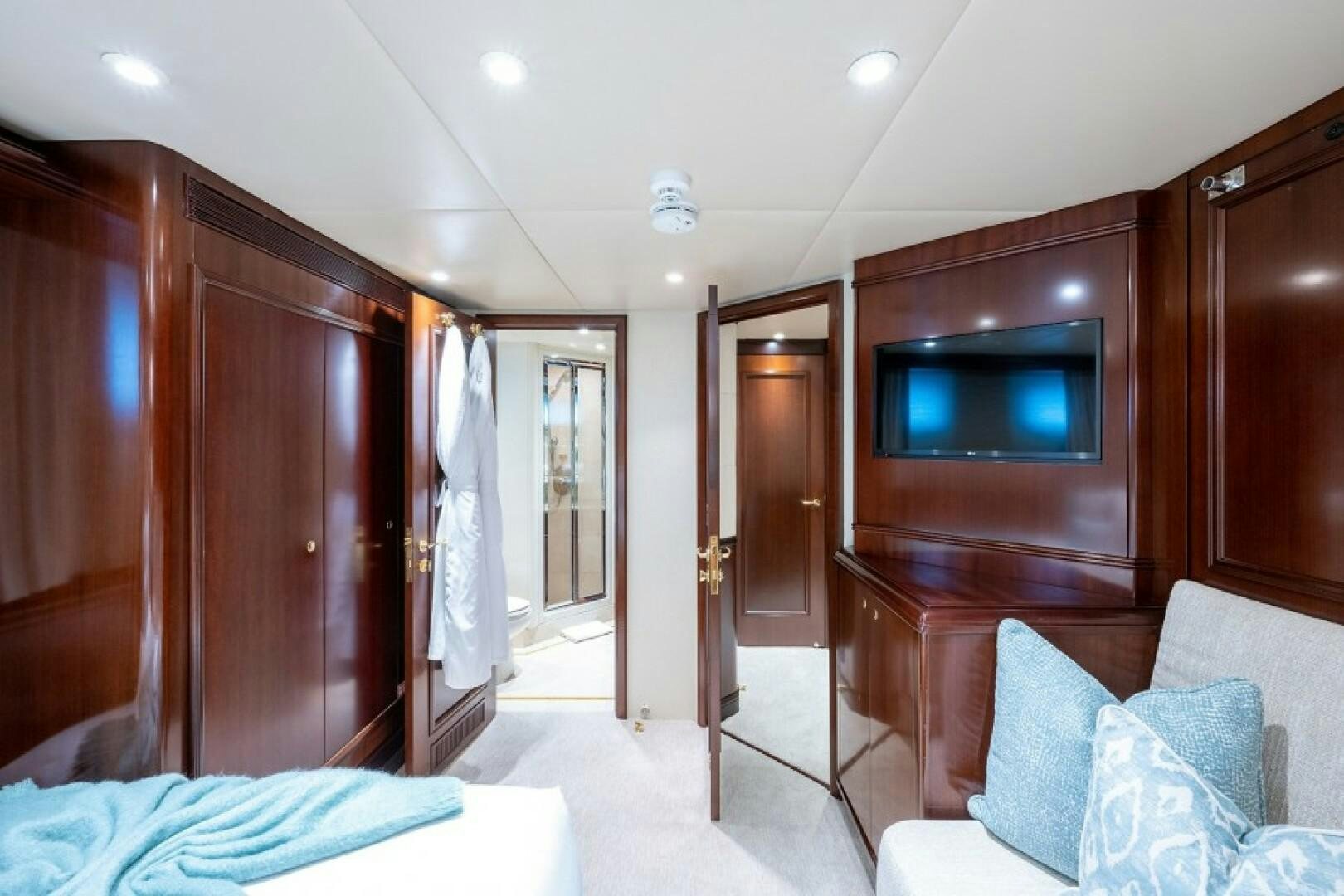 a room with a tv and a bed aboard STARSHIP Yacht for Sale