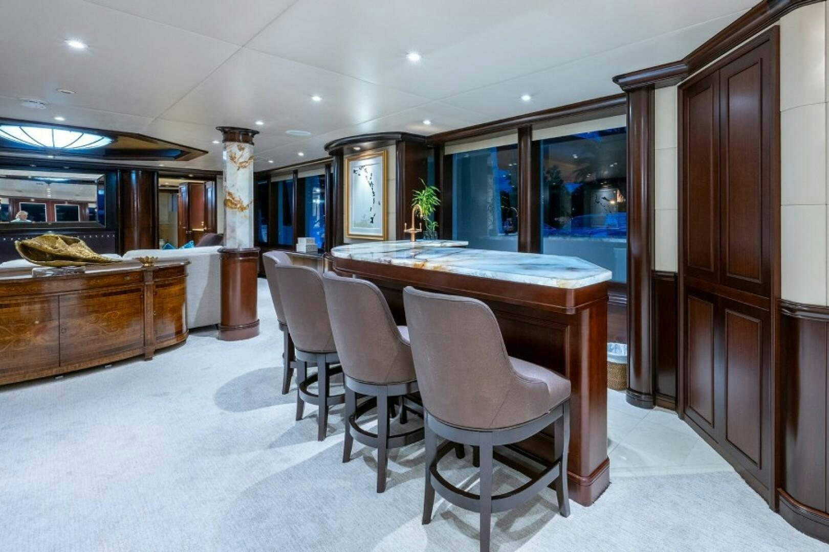 a room with a table chairs and cabinets aboard STARSHIP Yacht for Sale