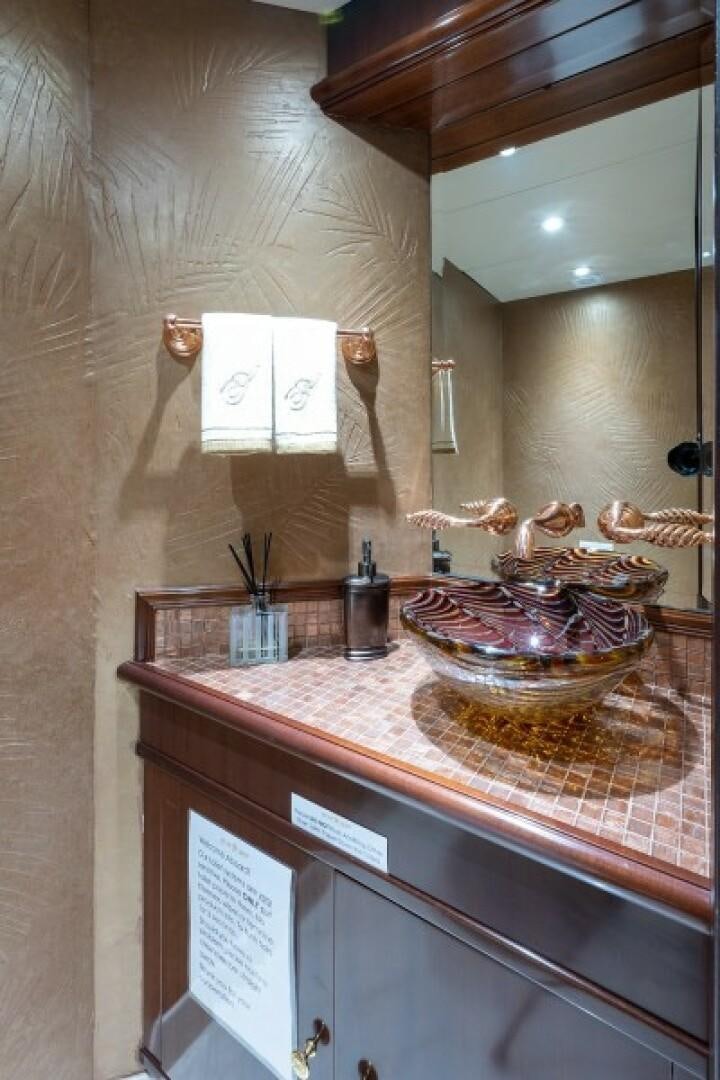 a bathroom with a countertop sink and mirror aboard STARSHIP Yacht for Sale