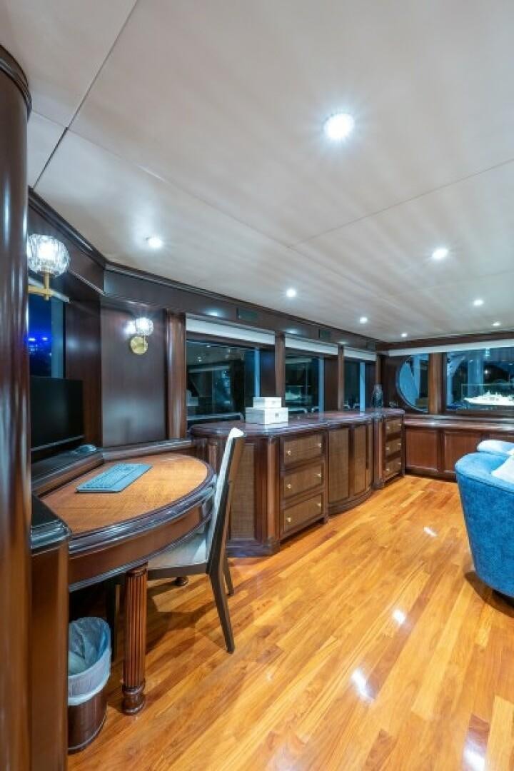 a kitchen with a bar and a table aboard STARSHIP Yacht for Sale