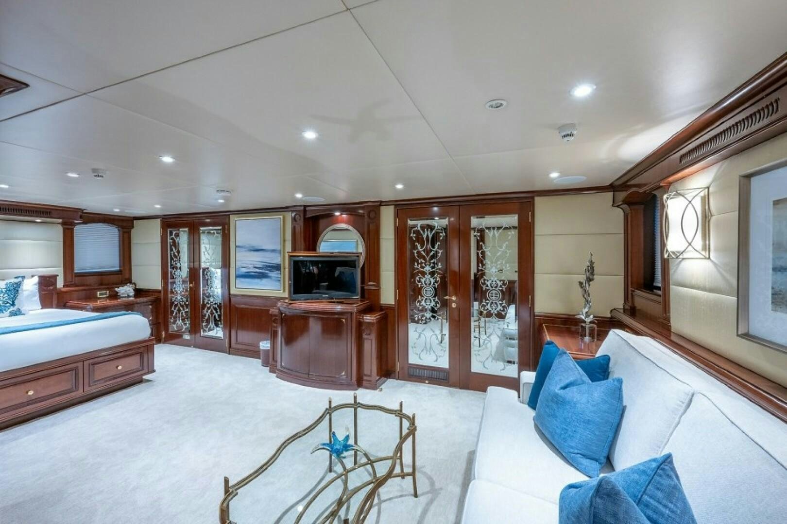 a large living room with a large mirror and a bed aboard STARSHIP Yacht for Sale