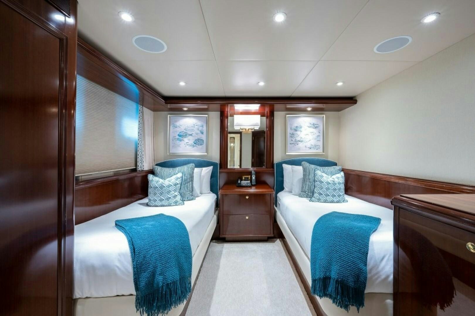 a room with a couple beds aboard STARSHIP Yacht for Sale