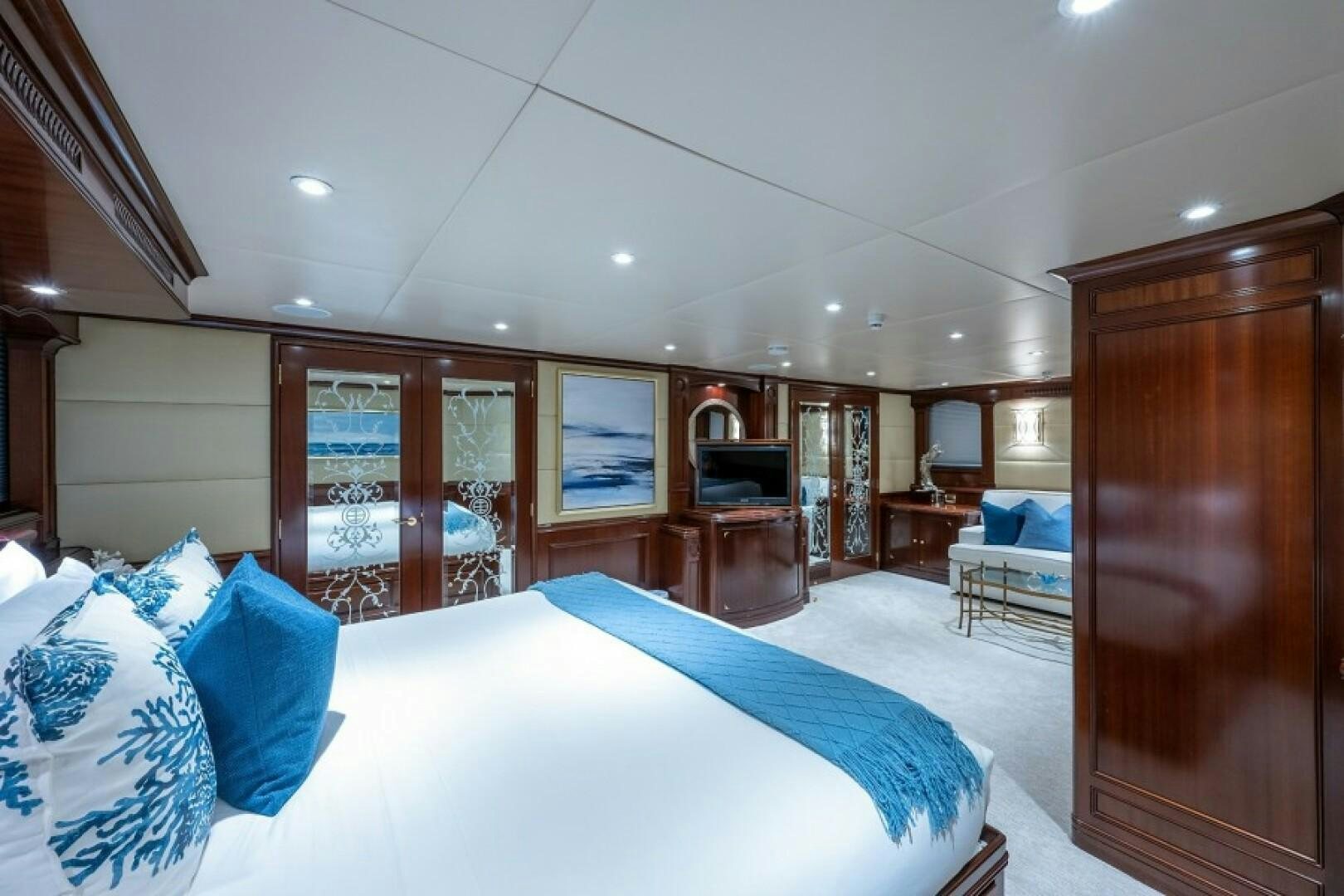a bedroom with a bed and a television aboard STARSHIP Yacht for Sale
