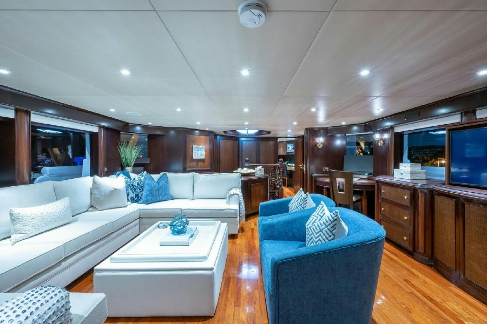 a living room with a couch and a television aboard STARSHIP Yacht for Sale