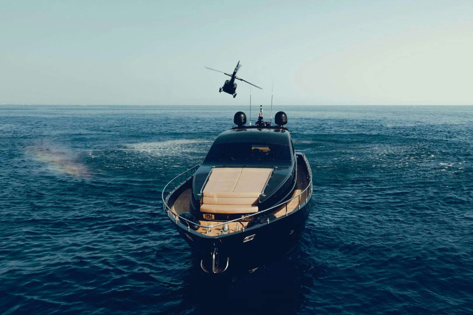 a helicopter flying over a boat in the ocean aboard BLACK ROCK Yacht for Sale