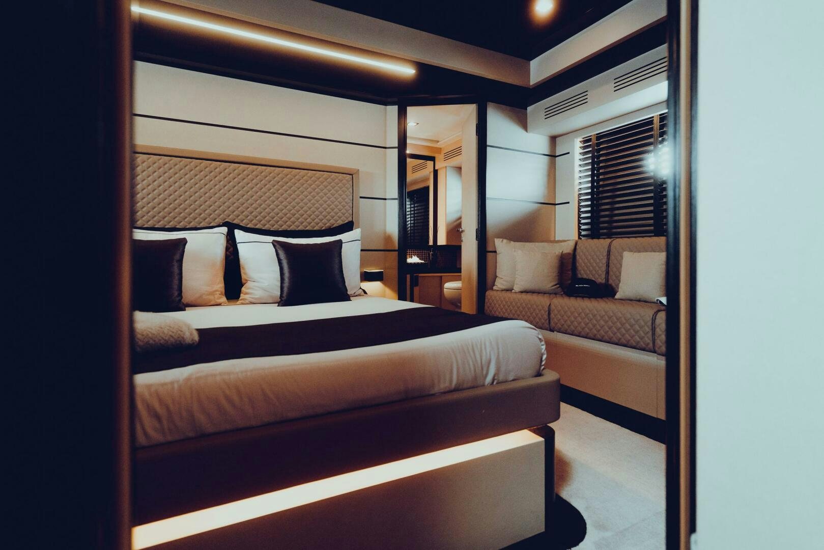 a room with a bed and a couch aboard BLACK ROCK Yacht for Sale